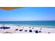 Expansive beach view with white sand, blue ocean, and beachgoers enjoying a sunny day at 18650 Gulf Blvd # 314, Indian Shores, FL 33785