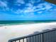 Beautiful beach view of pristine sand, calm ocean, and blue skies, showcasing the property's prime location at 18650 Gulf Blvd # 314, Indian Shores, FL 33785