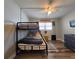 Bedroom featuring a bunk bed with a ceiling fan and a dresser on wood floors at 18650 Gulf Blvd # 314, Indian Shores, FL 33785