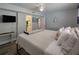 Bedroom featuring a king-size bed, and a bathroom door, complete with a ceiling fan at 18650 Gulf Blvd # 314, Indian Shores, FL 33785