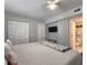 Bedroom showing a king-size bed, interior closets, a ceiling fan, and a door to the toilet at 18650 Gulf Blvd # 314, Indian Shores, FL 33785