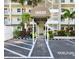 Inviting building entrance with covered walkway, lush landscaping, and dedicated parking spots at 18650 Gulf Blvd # 314, Indian Shores, FL 33785