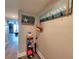 The hallway with decorative beach-themed art, storage shelf, hat rack, and modern beachy colors at 18650 Gulf Blvd # 314, Indian Shores, FL 33785