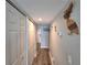 Hallway with wood-look flooring, closet, and decorative wooden pelican at 18650 Gulf Blvd # 314, Indian Shores, FL 33785