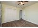 Bedroom features wood floors, closet, and neutral colored walls at 2165 Campus Dr, Clearwater, FL 33764