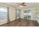 Bedroom with wood floors, built-in shelves, and sliding glass door at 2165 Campus Dr, Clearwater, FL 33764
