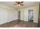 Bright bedroom features wood floors, closet, and adjoining bathroom at 2165 Campus Dr, Clearwater, FL 33764