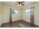 Bedroom with wood floor, ceiling fan, and lots of sunlight at 2165 Campus Dr, Clearwater, FL 33764