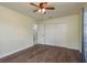 Bedroom features wood floors, closet, and adjoining bathroom at 2165 Campus Dr, Clearwater, FL 33764
