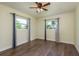 Bedroom with wood floors, ceiling fan, and lots of sunlight at 2165 Campus Dr, Clearwater, FL 33764