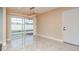 Bright dining area with tiled floors and a view of the screened-in pool through sliding glass doors at 2165 Campus Dr, Clearwater, FL 33764