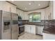 Modern kitchen with stainless steel appliances, white cabinets, and stylish backsplash at 2165 Campus Dr, Clearwater, FL 33764