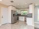 Modern kitchen with stainless steel appliances, white cabinets, and stylish backsplash at 2165 Campus Dr, Clearwater, FL 33764