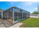 Screened-in pool with stone patio, creating a tranquil outdoor living space that enhances the home's value at 2165 Campus Dr, Clearwater, FL 33764