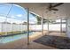 Screened-in pool area features a pool, patio, and ceiling fan at 2165 Campus Dr, Clearwater, FL 33764