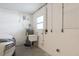 Functional utility sink area featuring water heater and electrical panel at 2165 Campus Dr, Clearwater, FL 33764