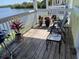 Outdoor balcony featuring waterfront view, chairs, plants, and grill at 219 Pompano Se Dr # D, St Petersburg, FL 33705