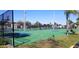 A fenced in basketball court with tennis courts in the background on a sunny day at 219 Pompano Se Dr # D, St Petersburg, FL 33705
