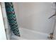 Well-lit bathroom with modern shower curtain and convenient shelving for storage at 219 Pompano Se Dr # D, St Petersburg, FL 33705