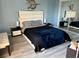 Serene bedroom retreat with sleek furnishings, ample lighting, and hardwood floors at 219 Pompano Se Dr # D, St Petersburg, FL 33705