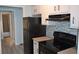 Kitchen view with black appliances and blue backsplash at 219 Pompano Se Dr # D, St Petersburg, FL 33705