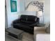 Comfortable living room with leather sofa, modern art, and stylish decor at 219 Pompano Se Dr # D, St Petersburg, FL 33705