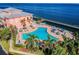 Beautiful view of community waterfront pool, lounge chairs and tropical landscaping at 219 Pompano Se Dr # D, St Petersburg, FL 33705