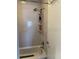 Clean shower/tub area with multiple shelves for storage at 219 Pompano Se Dr # D, St Petersburg, FL 33705