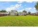 Large grassy backyard enclosed with a wooden fence, offering plenty of room for recreation and relaxation at 2306 Cheryl Rd, Largo, FL 33771