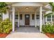 Inviting home entrance featuring a covered porch with decorative columns and a freshly painted front door at 2306 Cheryl Rd, Largo, FL 33771