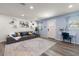 Bright living room with comfortable seating, stylish décor, and a calming blue accent wall at 2306 Cheryl Rd, Largo, FL 33771
