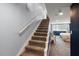 Carpeted staircase leading to an upper level, with a bedroom visible, highlighting the home's layout at 2306 Cheryl Rd, Largo, FL 33771