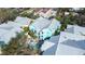 Aerial view of the property featuring a pool, colorful buildings, and lush landscaping at 3002 W Cleveland St # B9, Tampa, FL 33609