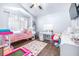 Colorful bedroom with wood-look floors, toys, and closet at 3002 W Cleveland St # B9, Tampa, FL 33609