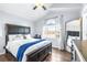 Primary bedroom with a bright window, wood-look flooring, and a ceiling fan at 3002 W Cleveland St # B9, Tampa, FL 33609