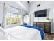 Primary bedroom with a vaulted ceiling, wood-look flooring, and a bright window at 3002 W Cleveland St # B9, Tampa, FL 33609