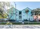 Charming turquoise condo building with lush landscaping and a welcoming entrance at 3002 W Cleveland St # B9, Tampa, FL 33609