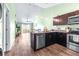 Open-concept kitchen with stainless steel appliances and eat-in dining at 3002 W Cleveland St # B9, Tampa, FL 33609