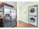 Close up of stainless steel refrigerator and stacked washer and dryer at 3002 W Cleveland St # B9, Tampa, FL 33609