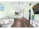 Living room with views to the kitchen and including a ceiling fan and wood flooring at 3002 W Cleveland St # B9, Tampa, FL 33609