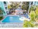 Beautiful community pool surrounded by lush landscaping and colorful buildings at 3002 W Cleveland St # B9, Tampa, FL 33609