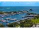 Sweeping aerial view of a marina with numerous boats docked, complemented by modern architecture and lush greenery along the waterfront at 301 1St S St # 1601, St Petersburg, FL 33701