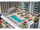 Stunning aerial view of the rooftop pool and lounge area with palm trees and stylish outdoor seating at 301 1St S St # 1601, St Petersburg, FL 33701
