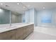 Modern bathroom features a double vanity, soaking tub, and glass enclosed shower at 301 1St S St # 1601, St Petersburg, FL 33701
