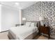 Bedroom featuring a cozy bed, side table and vibrant botanical wallpaper at 301 1St S St # 1601, St Petersburg, FL 33701