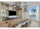 Modern dining room features a long table with seating for eight under decorative lighting, with a water view at 301 1St S St # 1601, St Petersburg, FL 33701