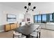 Open-concept dining and living area featuring stylish decor, wet bar, and water views from floor-to-ceiling windows at 301 1St S St # 1601, St Petersburg, FL 33701