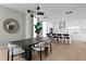 Dining area with a modern table, chairs, and light fixture, adjacent to the kitchen with an island and bar stools at 301 1St S St # 1601, St Petersburg, FL 33701