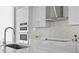 Modern white kitchen with stainless steel appliances and decorative backsplash at 301 1St S St # 1601, St Petersburg, FL 33701