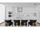 Modern white kitchen featuring sleek cabinets, stainless appliances and an island with bar seating at 301 1St S St # 1601, St Petersburg, FL 33701
